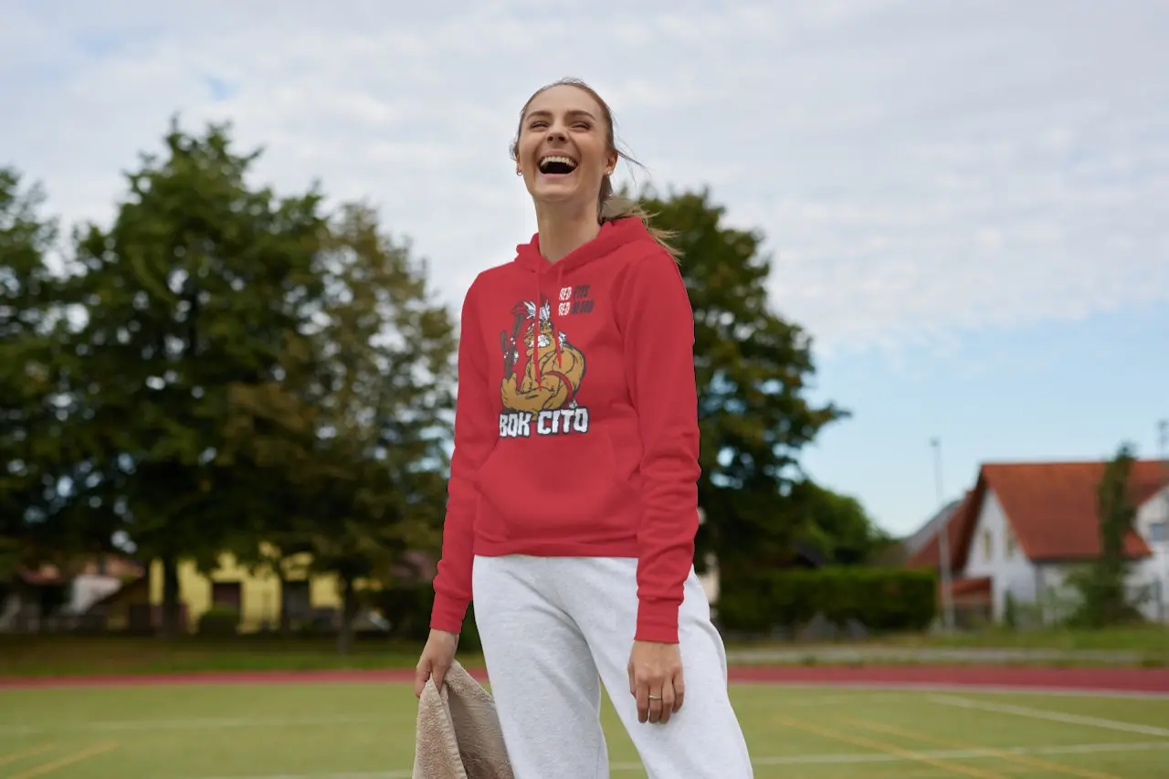 Woman laughing while wearing a Bok Cito fan hoodie